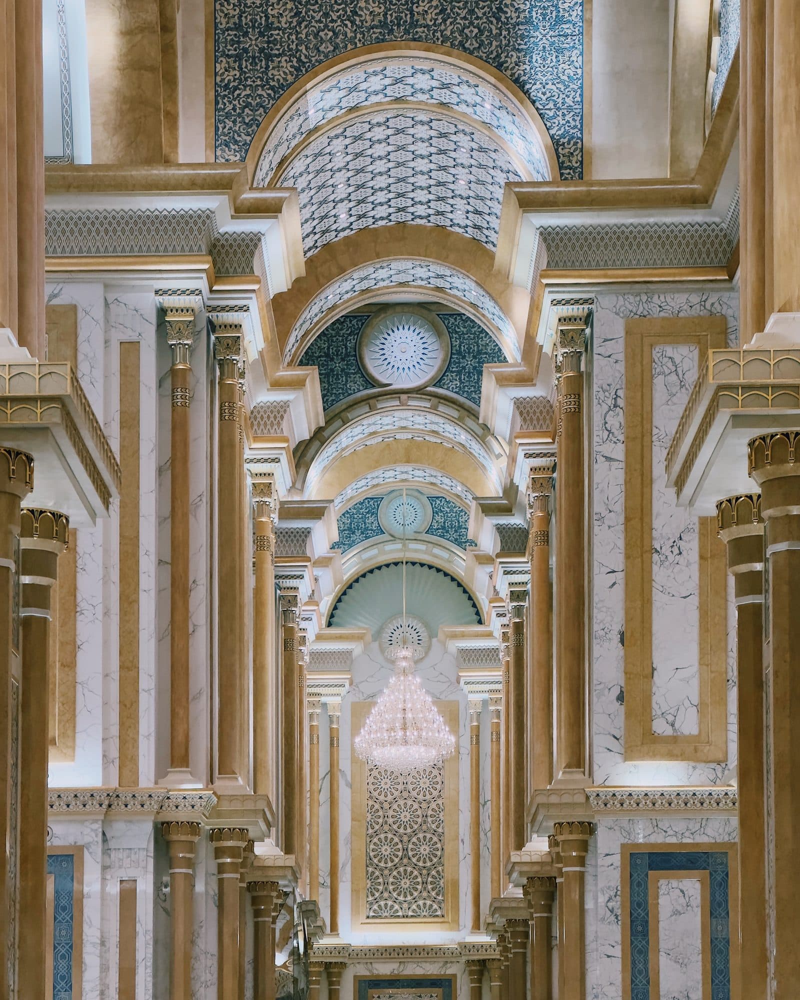 A grand hallway with warm light and ornate ceilings