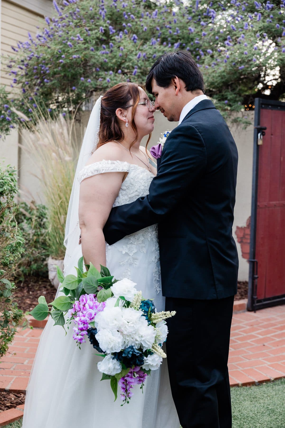 The couple close together in a quiet moment, foreheads touching.