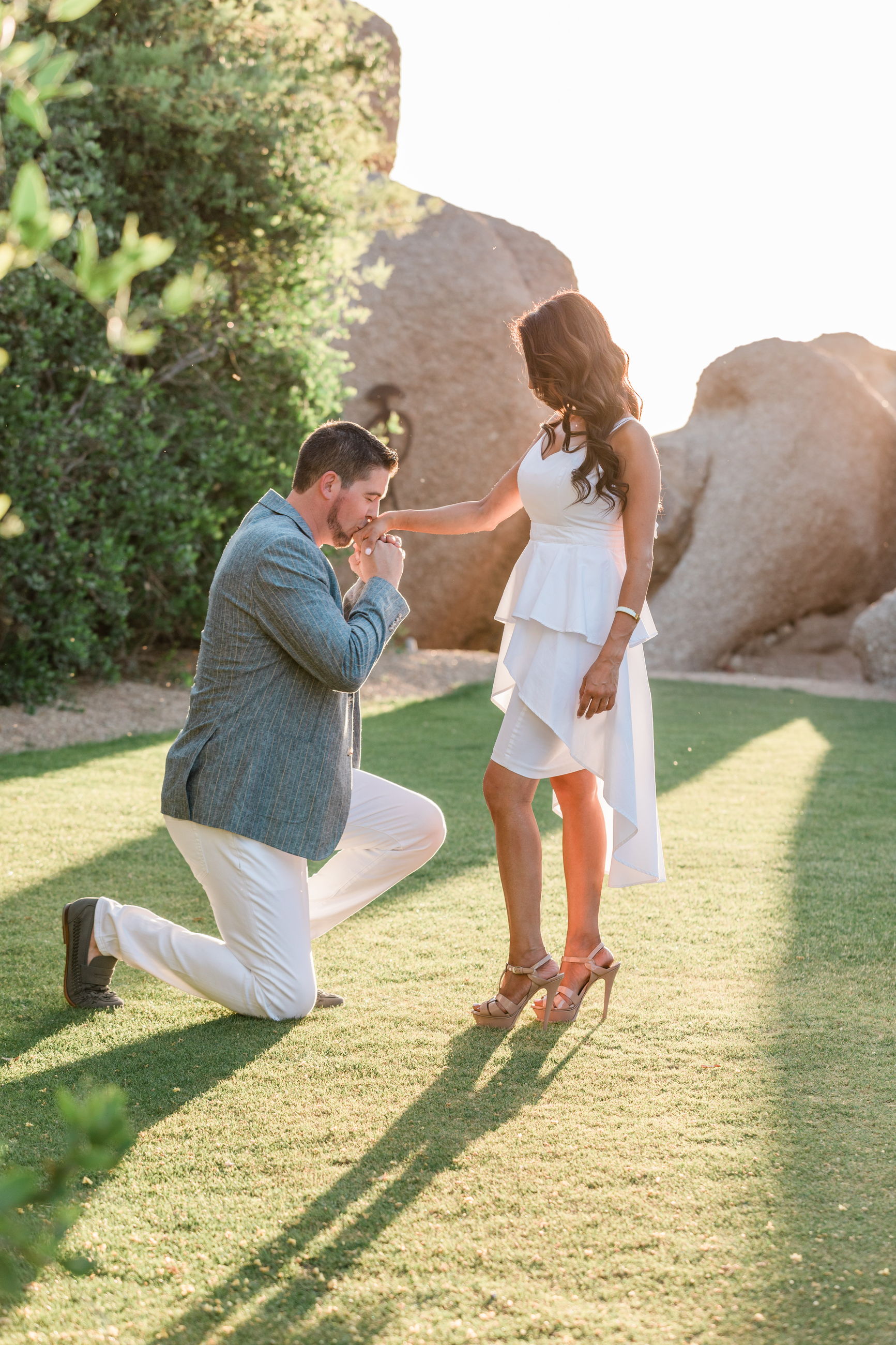 A couple together among sunlit desert boulders